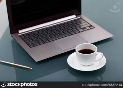 Image of business table with a cup of coffee and norebook