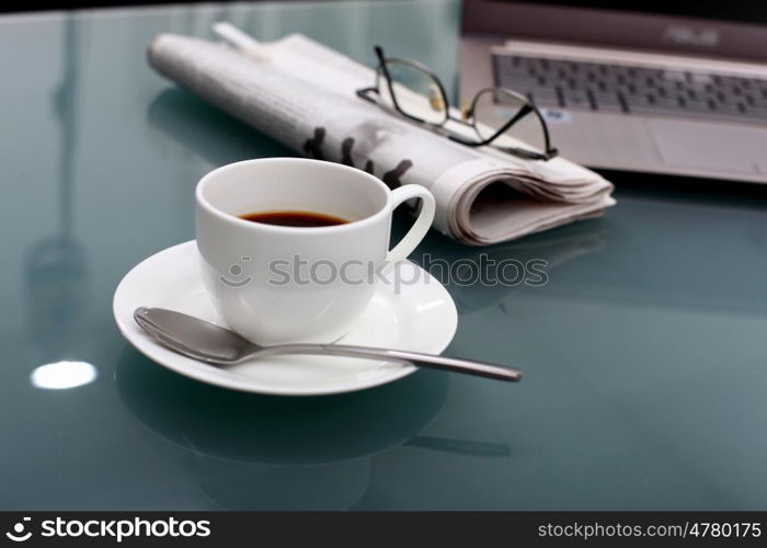 Image of business table with a cup of coffee and norebook