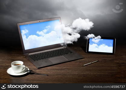 Image of business workplace with laptop, ipad, cup of coffee