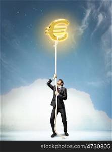 Image of businessman climbing rope. Image of businessman climbing rope attached to euro sign