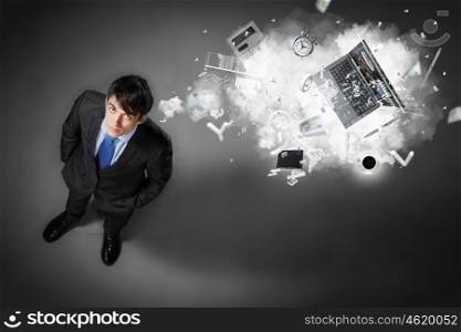 Image of businessman top view. Image of business objects flying in air top view against businessman background