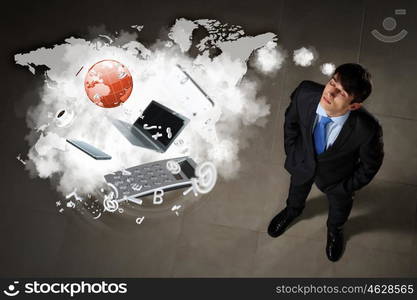 Image of businessman top view. Image of business objects flying in air top view against businessman background