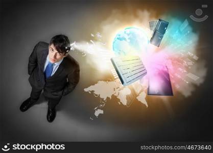Image of businessman top view. Image of business objects flying in air top view against businessman background