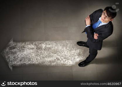 Image of businessman top view. Top view of businessman standing against directions background