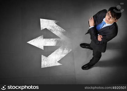 Image of businessman top view. Top view of businessman standing against directions background