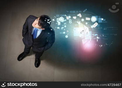 Image of businessman top view. Top view of young businessman making decision