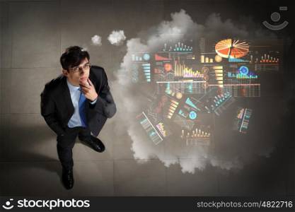 Image of businessman top view. Top view of young businessman making decision diagram in air