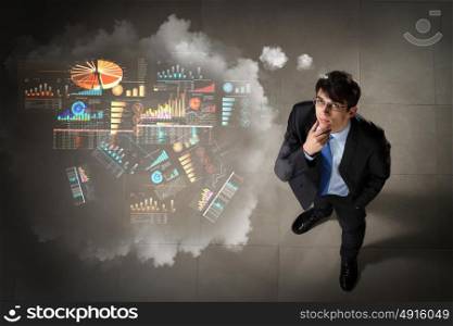 Image of businessman top view. Top view of young businessman making decision diagram in air