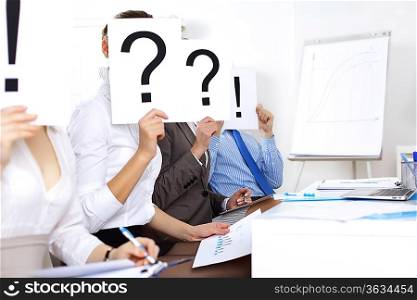 Image of businessmen in office with question marks