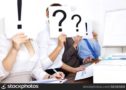 Image of businessmen in office with question marks