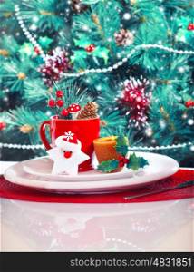 Image of Christmas eve table decoration, Christmastime still life over gorgeous decorated Christmas tree background, luxury festive red and white dinnerware, New Year party, winter holidays