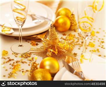 Image of Christmastime table decoration, luxury white dishware served with silver cutlery adorned with glowing glitters, golden holiday decorations, festive utensil, romance New Year dinner