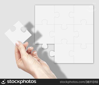 Image of colour puzzle pieces and human hand