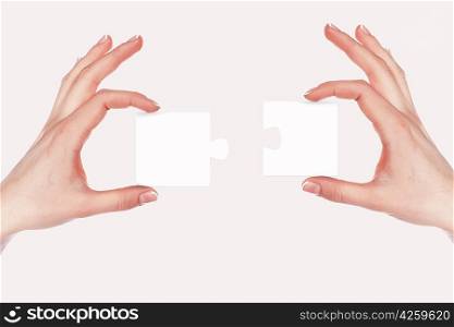 Image of colour puzzle pieces and human hand