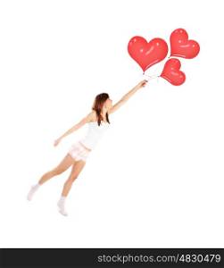Image of cute female flying on red heart-shaped balloons, smiling woman isolated on white background, freedom lifestyle, Valentine day, romantic dream, first affection, love and happiness concept