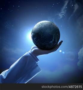 Image of earth planet on hand. Hand of businessman holding earth planet against illustration background