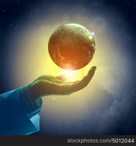 Image of earth planet on hand. Hand of businessman holding earth planet against illustration background