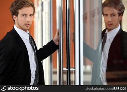 Image of executive reflected in glass