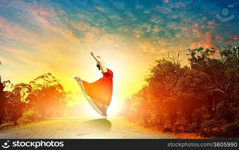 Image of female ballet dancing outdoor against sunset background