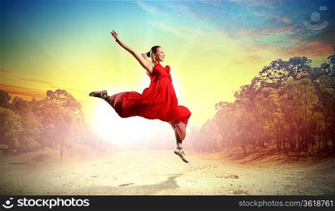 Image of female ballet dancing outdoor against sunset background