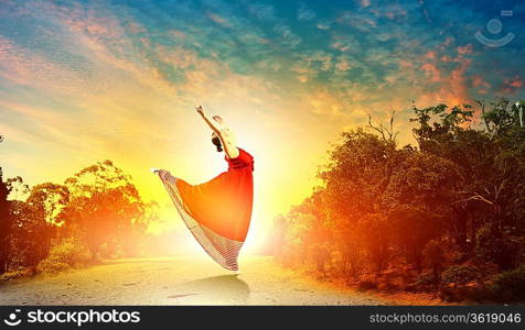 Image of female ballet dancing outdoor against sunset background