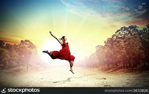 Image of female ballet dancing outdoor against sunset background