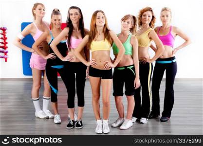 image of fit women at gym posing for camera