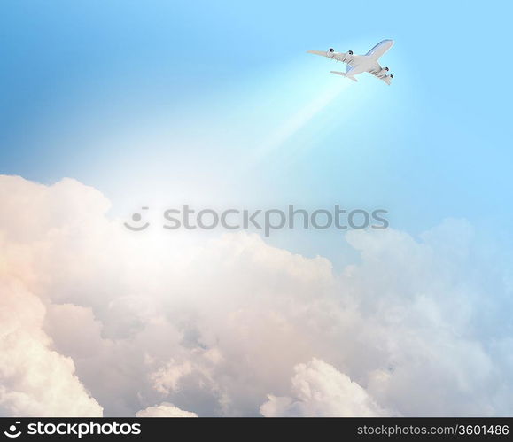 Image of flying airplane in clear sky with sun at background