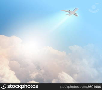 Image of flying airplane in clear sky with sun at background