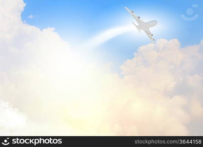 Image of flying airplane in clear sky with sun at background