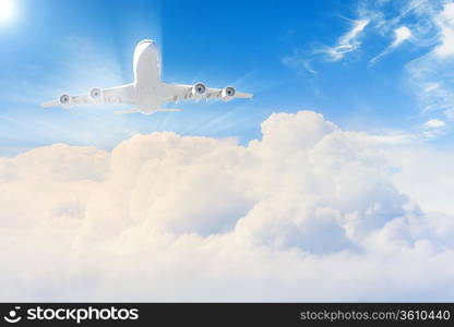 Image of flying airplane in sky with clouds at background