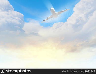 Image of flying airplane in sky with clouds at background