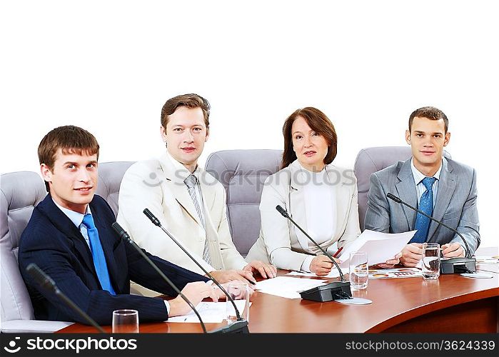 Image of four businesspeople discussing at meeting