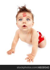 Image of funny baby boy crawling in studio, happy child with red kiss on the forehead isolated on white background, Valentine day, romantic holiday, adorable kid, love and care concept