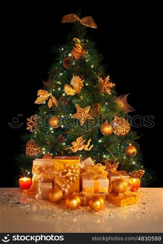 Image of gifts under beautiful Christmas tree isolated on black background, green fir tree decorated with golden balls, stars, angels and garland, different wrapped New Year presents, xmas surprise