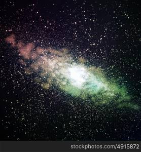 Image of glowing galaxy against black space and stars