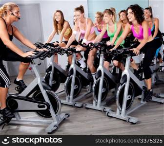 image of group of people doing exercise on a bike in a gym