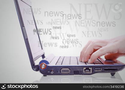 Image of hand on the laptop keyboard with the word news out of the screen.