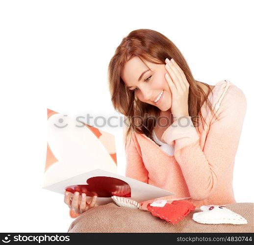 Image of happy beautiful female reading romantic greeting card with big red heart, attractive brunette woman got love letter, cheerful girl expressing happiness on Valentine day, in love concept