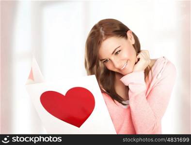 Image of happy beautiful female reading romantic postcard with big red heart, attractive brunette woman got sensual greeting card and isolated on white background, Valentine day,love concept