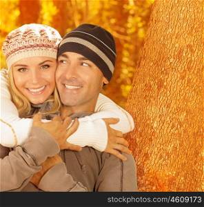 Image of happy young family relaxed in autumnal backyard, first romantic dating, closeup portrait of beautiful smiling couple wearing warm stylish hats, romance lifestyle, autumn season, love concept