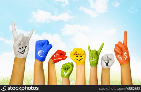 Image of human hands in colorful paint with smiles. Add color to life