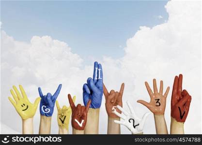 Image of human hands in colorful paint with smiles. Add color to life