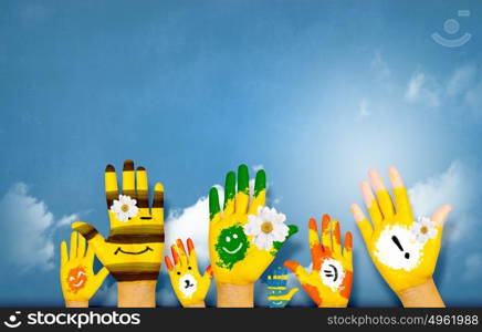 Image of human hands in colorful paint with smiles. Add color to life