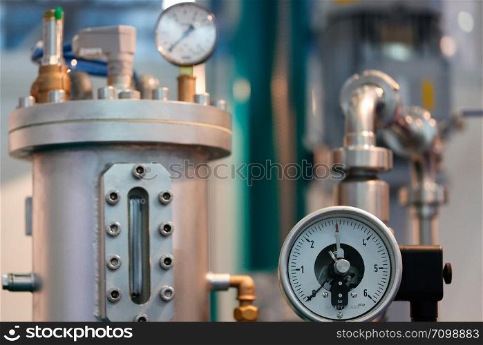 Image of industrial equipment with focus on mechanical pressure gauge.