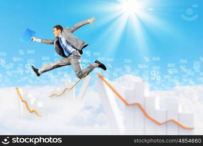 Image of jumping businessman. Image of a businessman jumping high against blue sky background