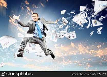 Image of jumping businessman. Image of a businessman jumping high against blue sky background