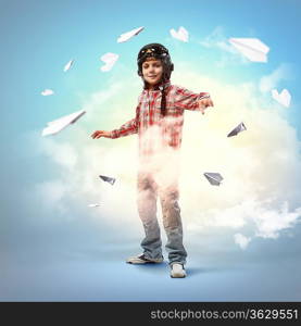 Image of little boy in pilots helmet with paper airplanes in background