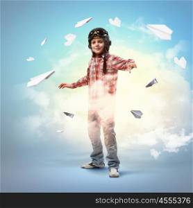 Image of little boy in pilots helmet with paper airplanes in background