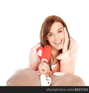 Image of lovely joyful woman sitting down and covered blanket with red handmade heart-shaped soft toy, isolated on white background, playful facial expression, Valentines day, love concept&#xA;